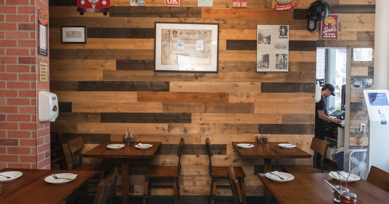 Interior, tables with tableware and chairs