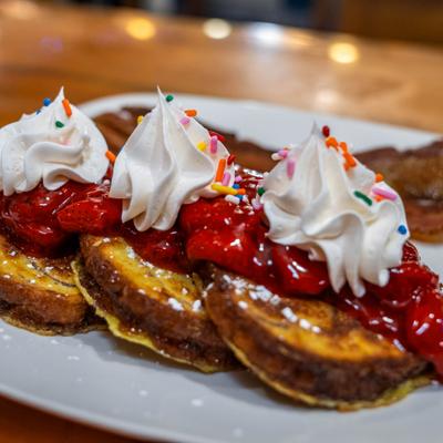 Classic French toast topped with strawberry sauce and whipped cream.