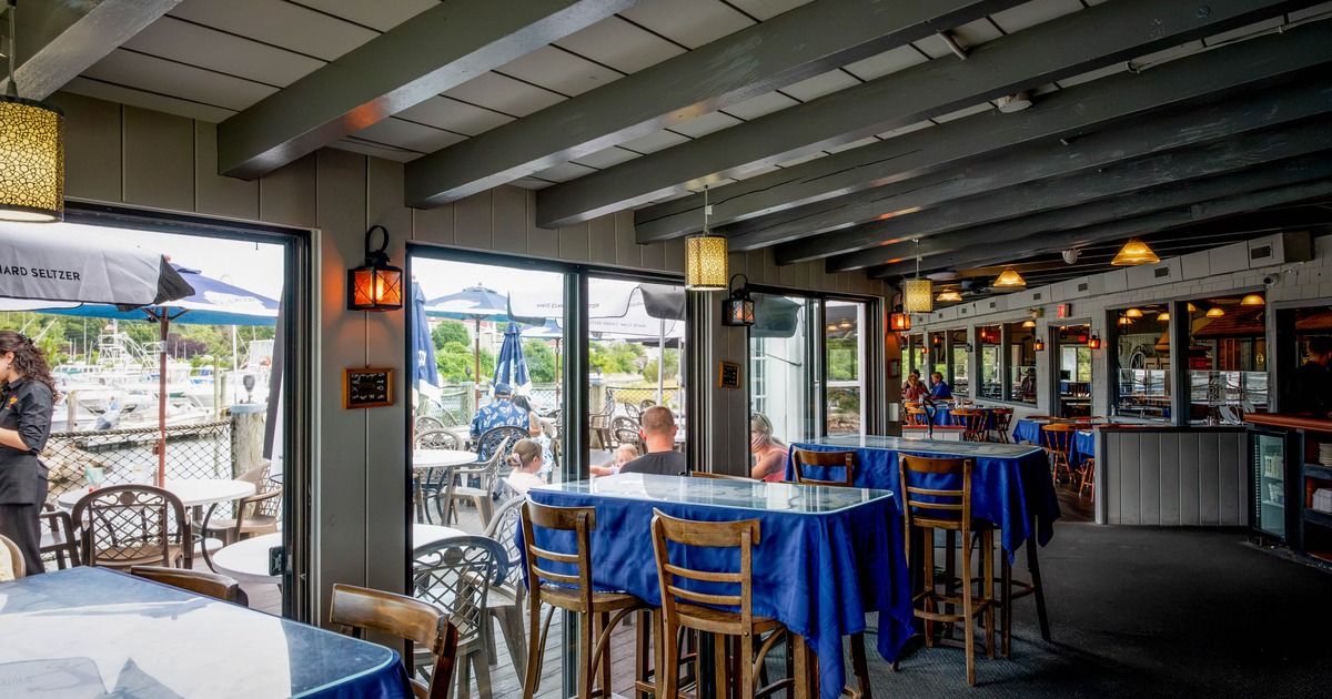 Interior of a restaurant with blue tablecloths and wooden beams