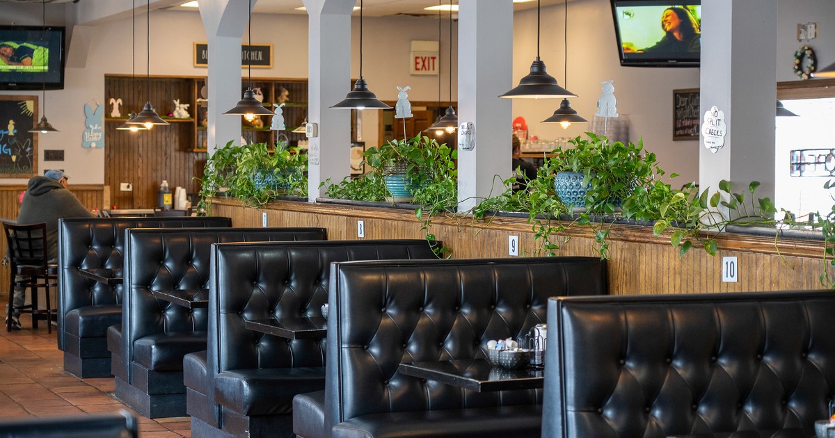 Cozy interior dining area with lined-up black upholstered dining booths