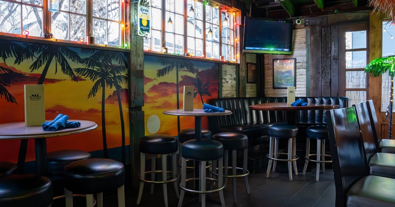 Interior, high seating area, high tables with bar stools, corner booth, TV on the wall
