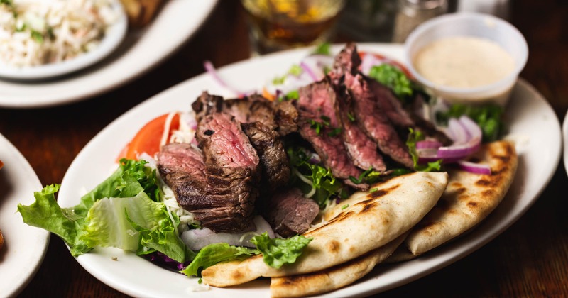 Steak Salad, with mixed greens, tomato, red onion , grated cheese and pita bread