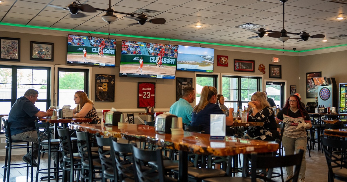 Interior, tables and bar stools, TV screens