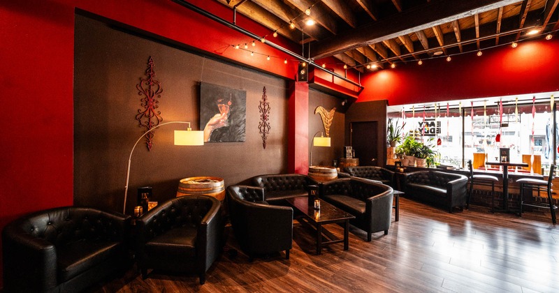 Interior, lounge area, padded two seater sofas with armchairs and coffee tables