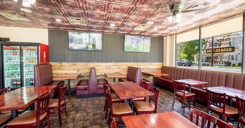 Interior, seating area with leather benches, tables and chairs