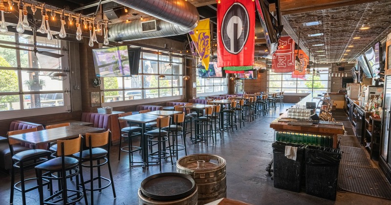 Interior, booths, tables with bar chairs and the bar