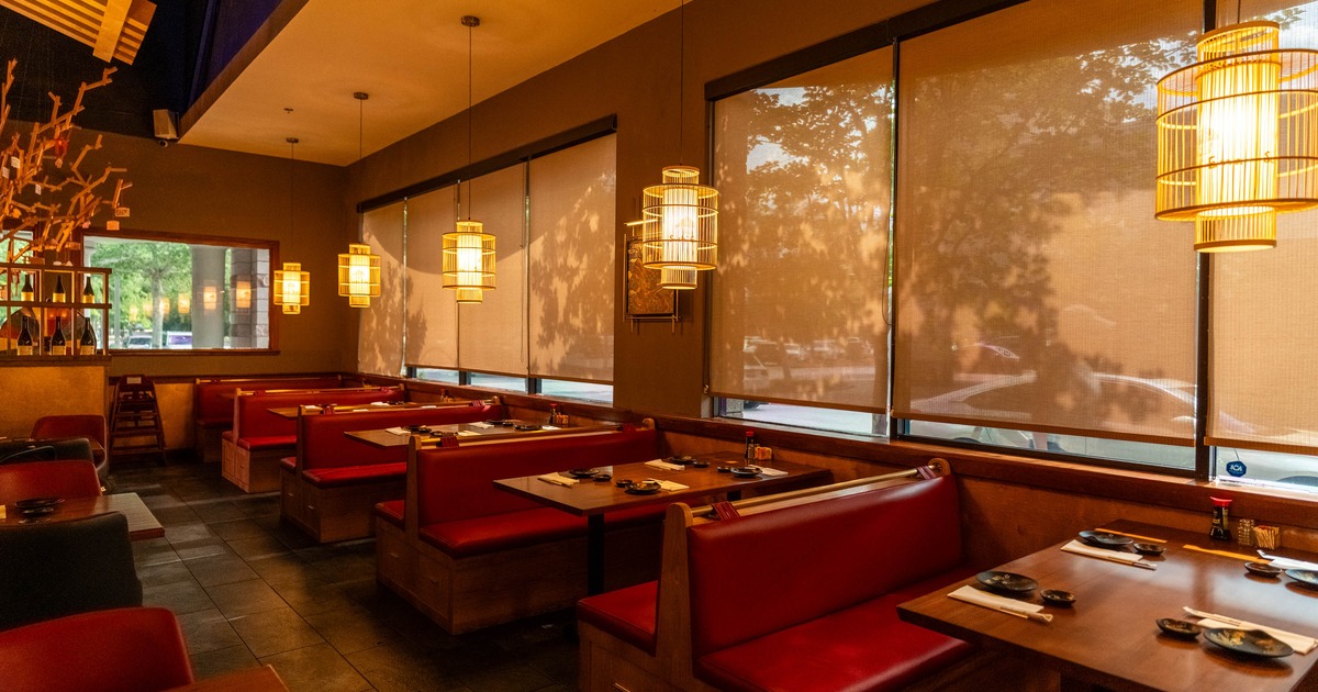 Interior with booth seating and prominent bamboo cage pendant lights