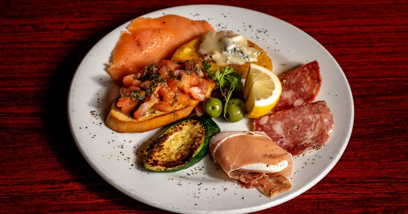 An antipasto platter with Italian meats, cheeses, and vegetables