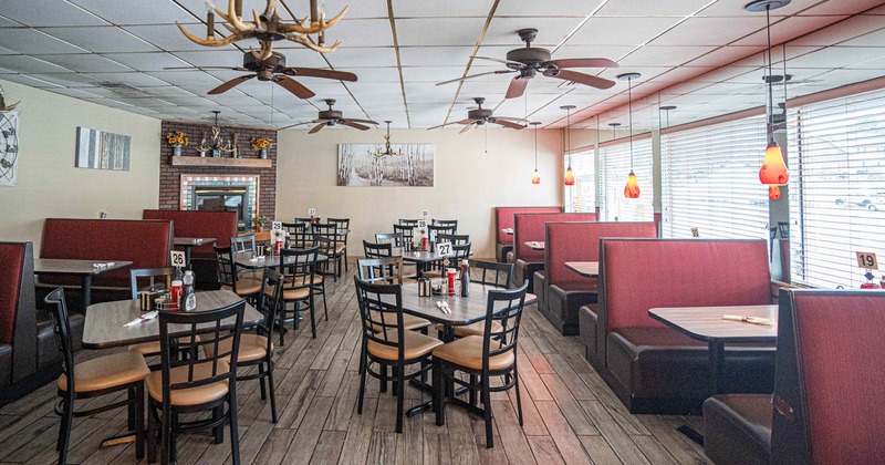 Dining area with ceiling fans and painting on the wall