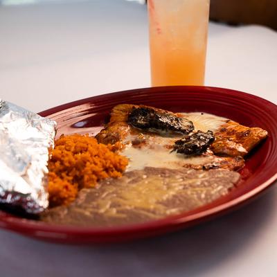Chorizo chicken with rice and refried beans, tortilla,  accompanied with Paloma cocktail.