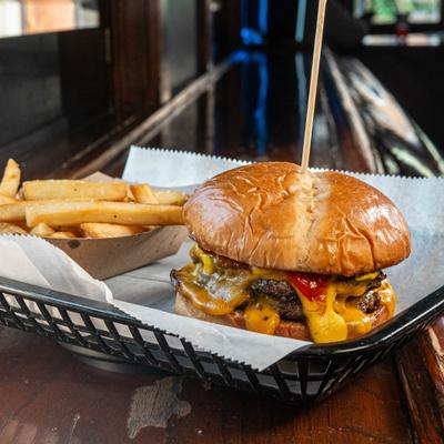 Smash Burger served on a tray with a side of fries.