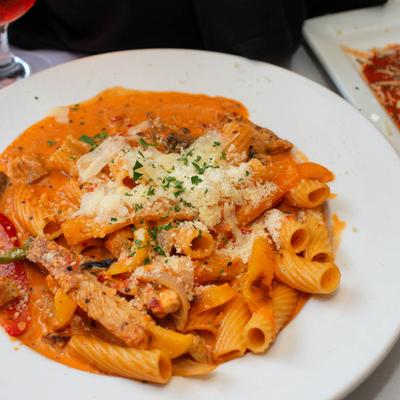 Rigatoni pasta in pink vodka sauce, with grilled chicken.