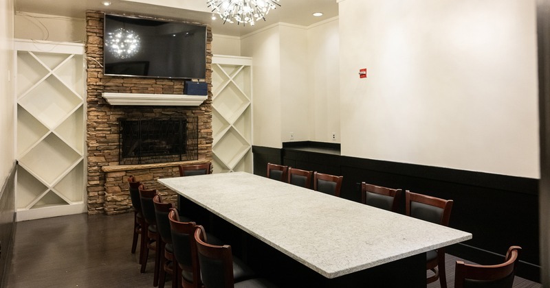Private dining room with a long table and upholstered chairs