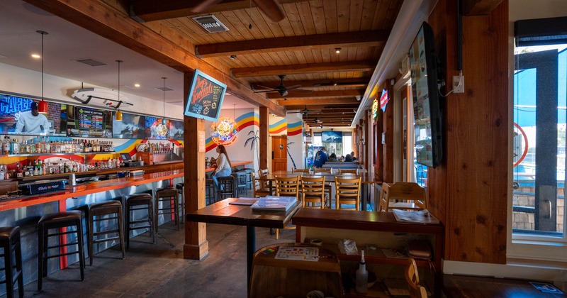 Interior of a cozy bar with wooden beams and colorful decor