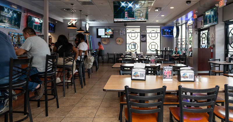 Exterior, bench seating and tables in front of restaurant