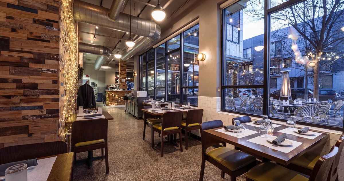 Interior, tables and chairs lined up next to the windows