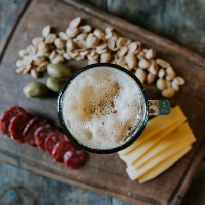 Charcuterie board with a beer mug, top view.