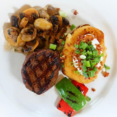 Filet Mignon, with baked potato, sauteed mushrooms, and veggies.