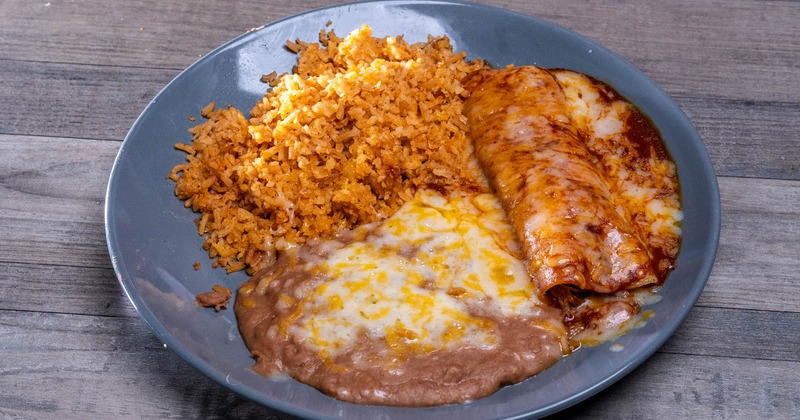 Enchiladas with rice and refried beans