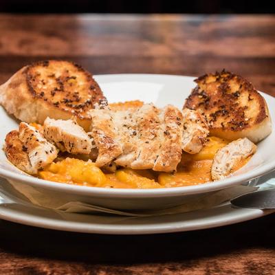 Cheese tortelloni in vodka cream sauce, with grilled chicken, and garlic bread.
