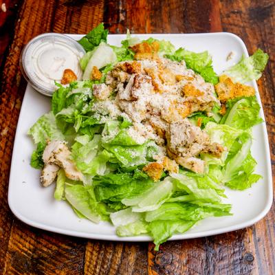 Caesar salad with dressing on the side.