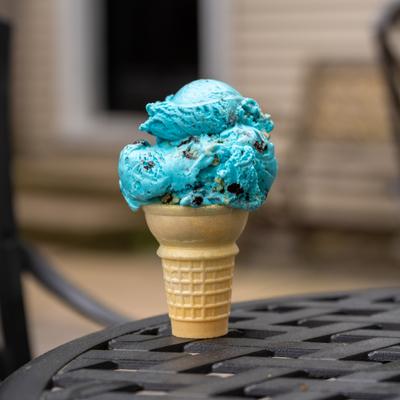 Blue ice cream cone on a patio table.