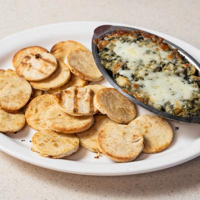 Spinach Artichoke Dip served with pita chips.