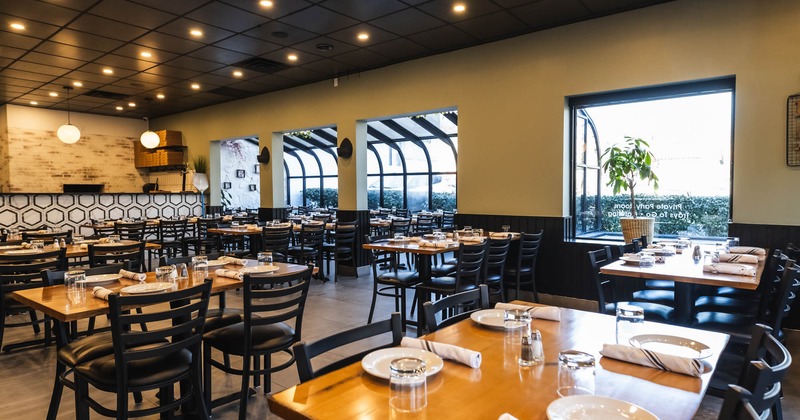 Interior, wide view, dining area, tables and chairs ready for guests