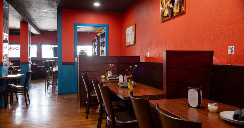 Interior, dining area with wooden furniture and red walls