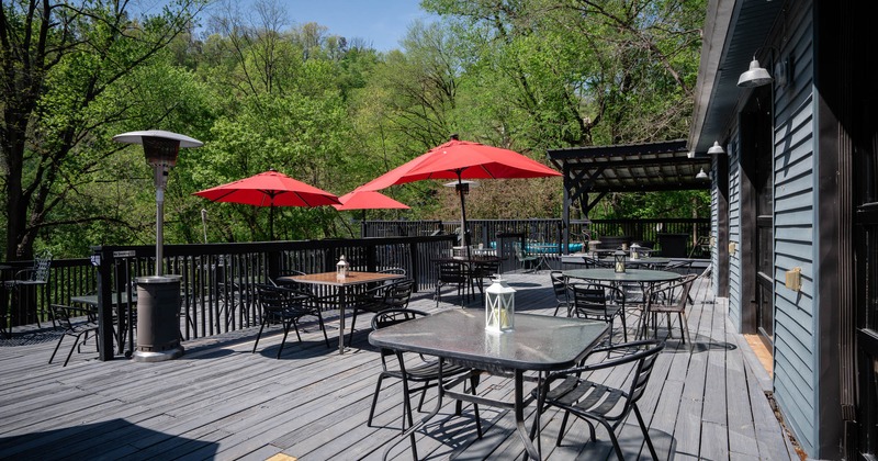 Patio, chairs, tables and red parasols