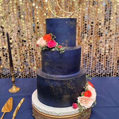 Dark blue three tier cake with small floral decoration