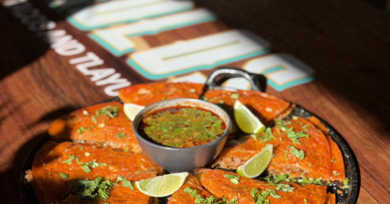 Birria pizza served with dipping broth