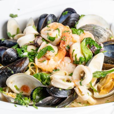 Seafood Florentine featuring a variety of shellfish and seafood.