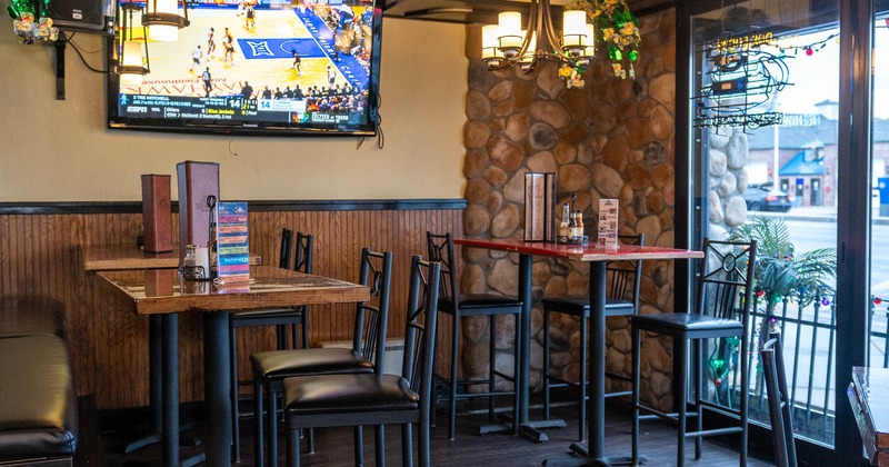 Interior, seating near the window side with the large TV screen on the wall