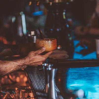 Bartender serving a cocktail drink at the bar