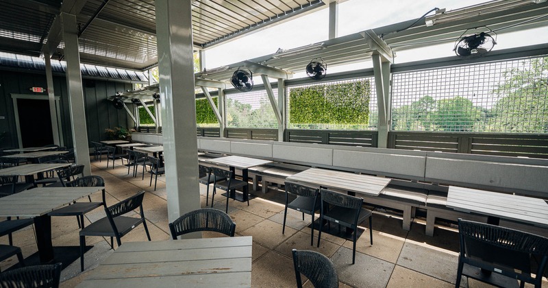 Exterior, rooftop area with tables, chairs and benches