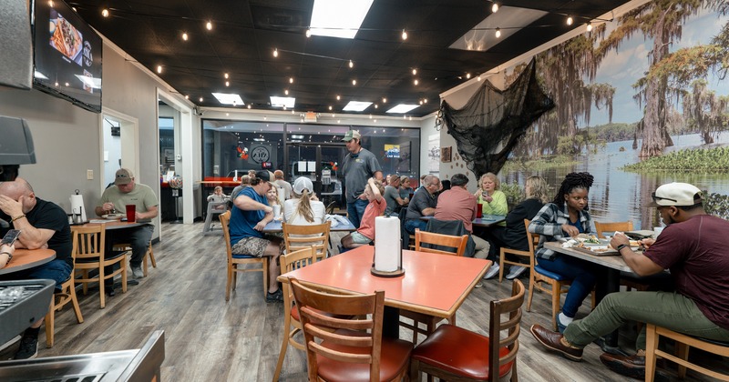Interior, diner area, tables and chairs, wide view, people seating