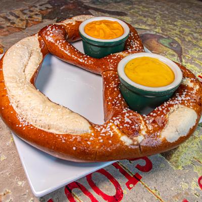 Mega Pretzel served with honey mustard and cheddar cheese sauce.