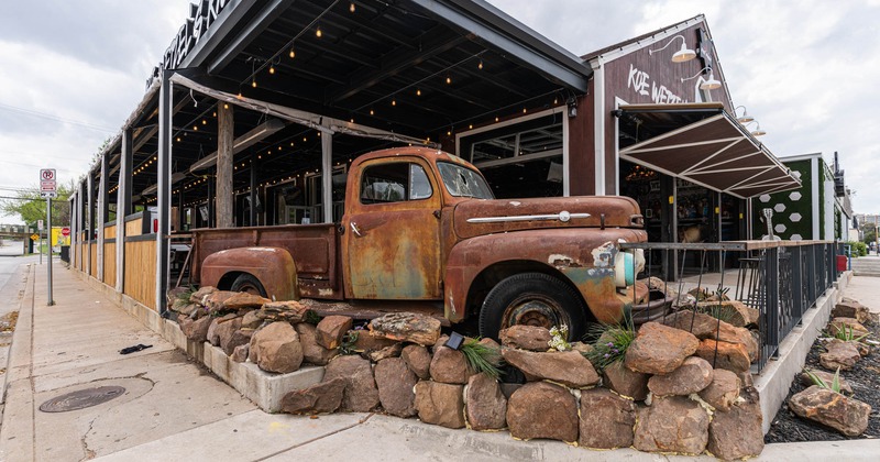 An old, rusty truck in front of the restaurant terrace as a decoration