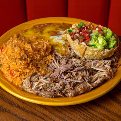 Tender shredded pork served with rice, refried beans, guacamole, and salsa.
