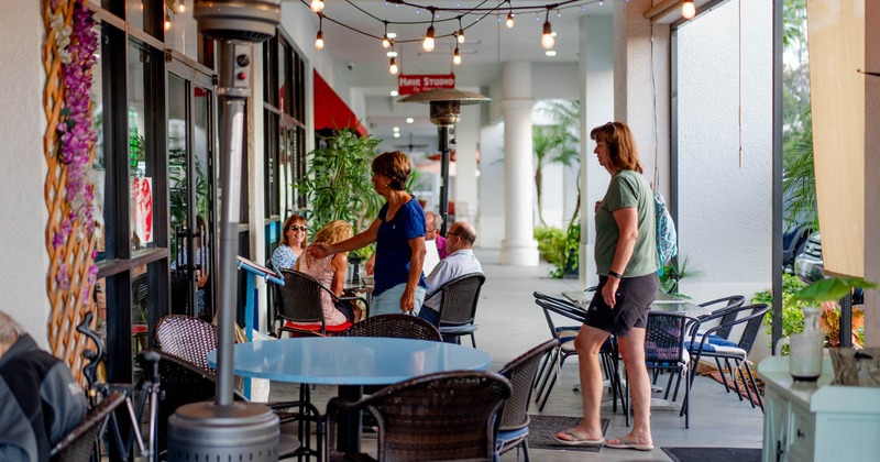 Side view to terrace, tables and chairs, people