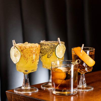 Assorted cocktails on a wooden counter.
