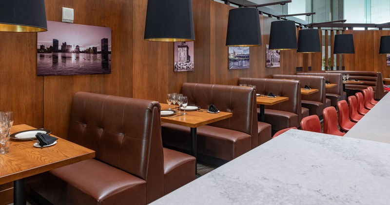 Interior, tables and brown leather seating booths