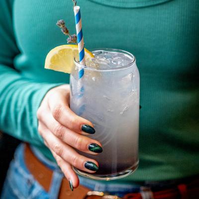 A hand holding a drink.
