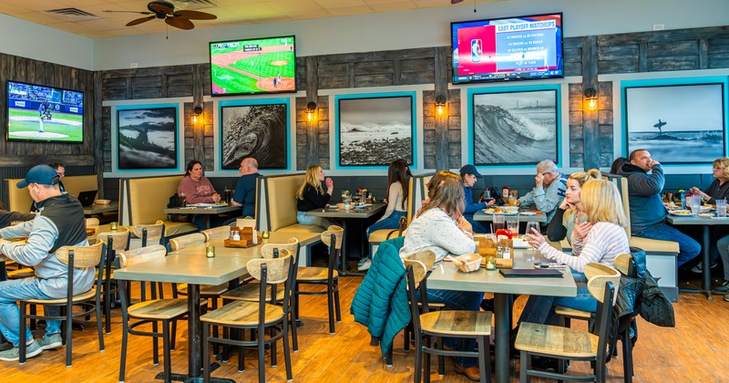 Interior, diner and bar area, people, tv screens above