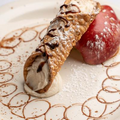 Cannoli and red apple.