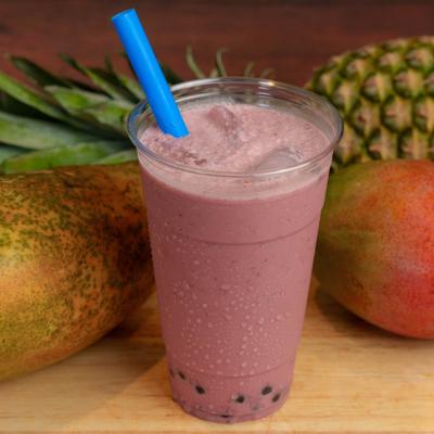 A cup of Taro Smoothie displayed  with papaya, mango, and pineapple.