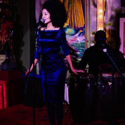 Performance scene with singer and artwork behind the stage.