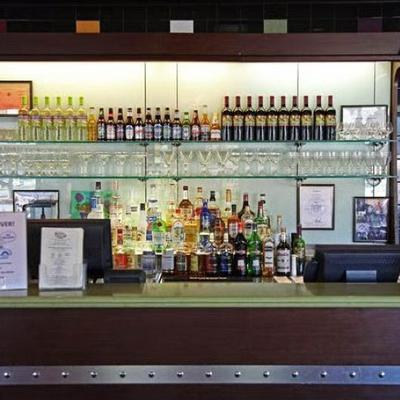 Various liquor bottles on the shelf.