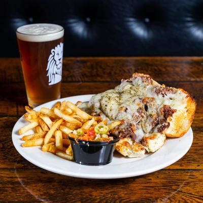 Italian beef sandwich plate and a glass of beer